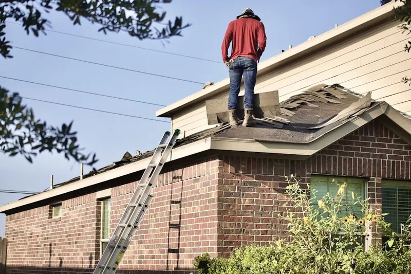 Professional roofer working on a residential roof in Singing Hills